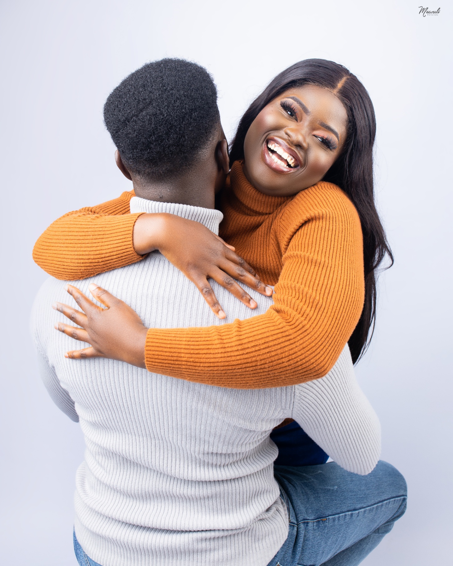Kingsley and Thelma embracing joyfully in a studio portrait.